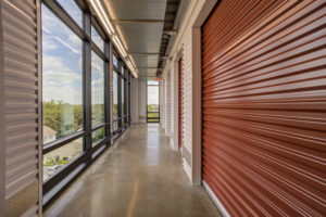 Storage center hallway with a glass corridor at Big Tex Storage Heights location 